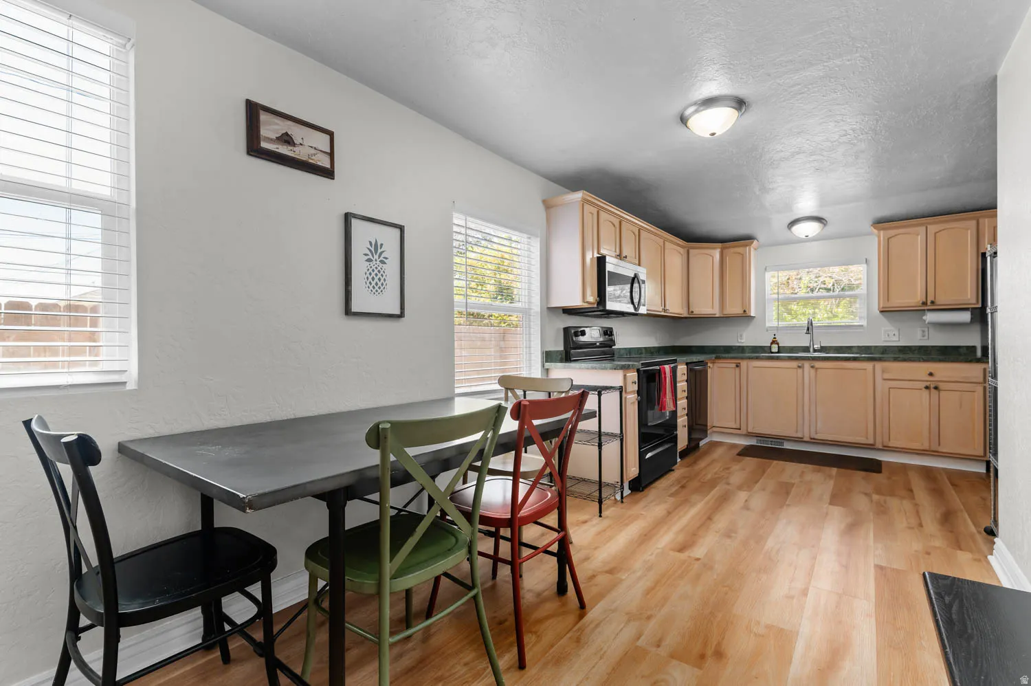 Kitchen and dining area featuring wood-finish flooring