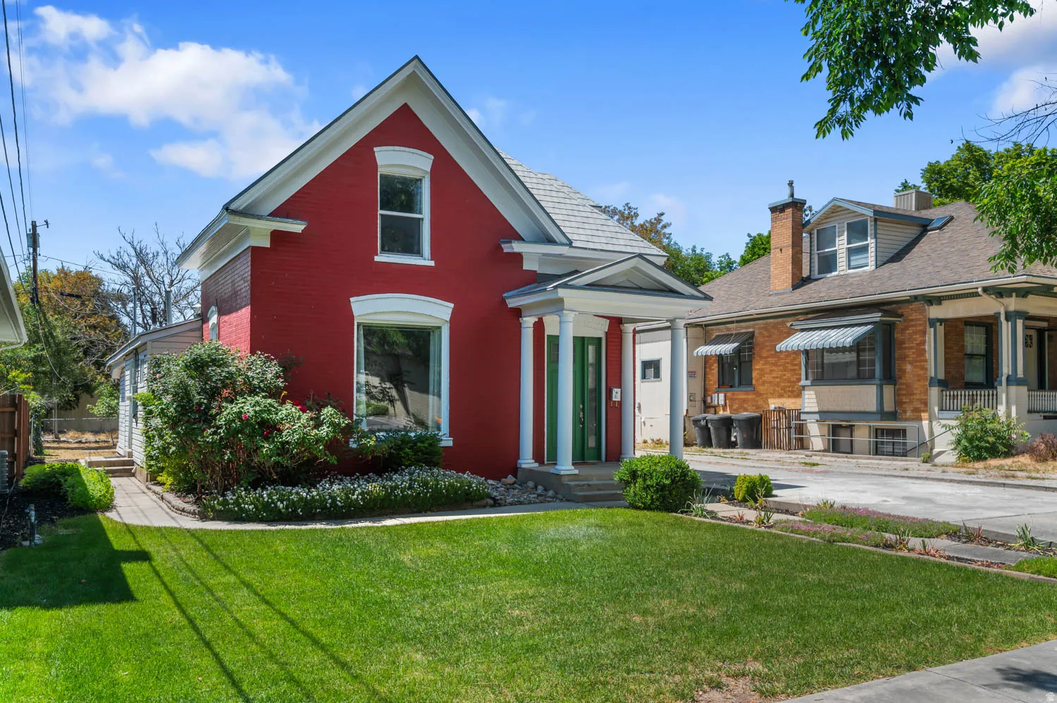 Red brick exterior with white trim accents and a pitched roof