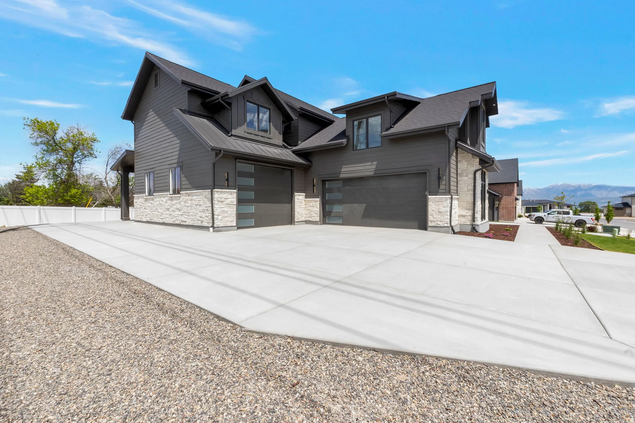 Contemporary exterior featuring dark siding and light stone accents