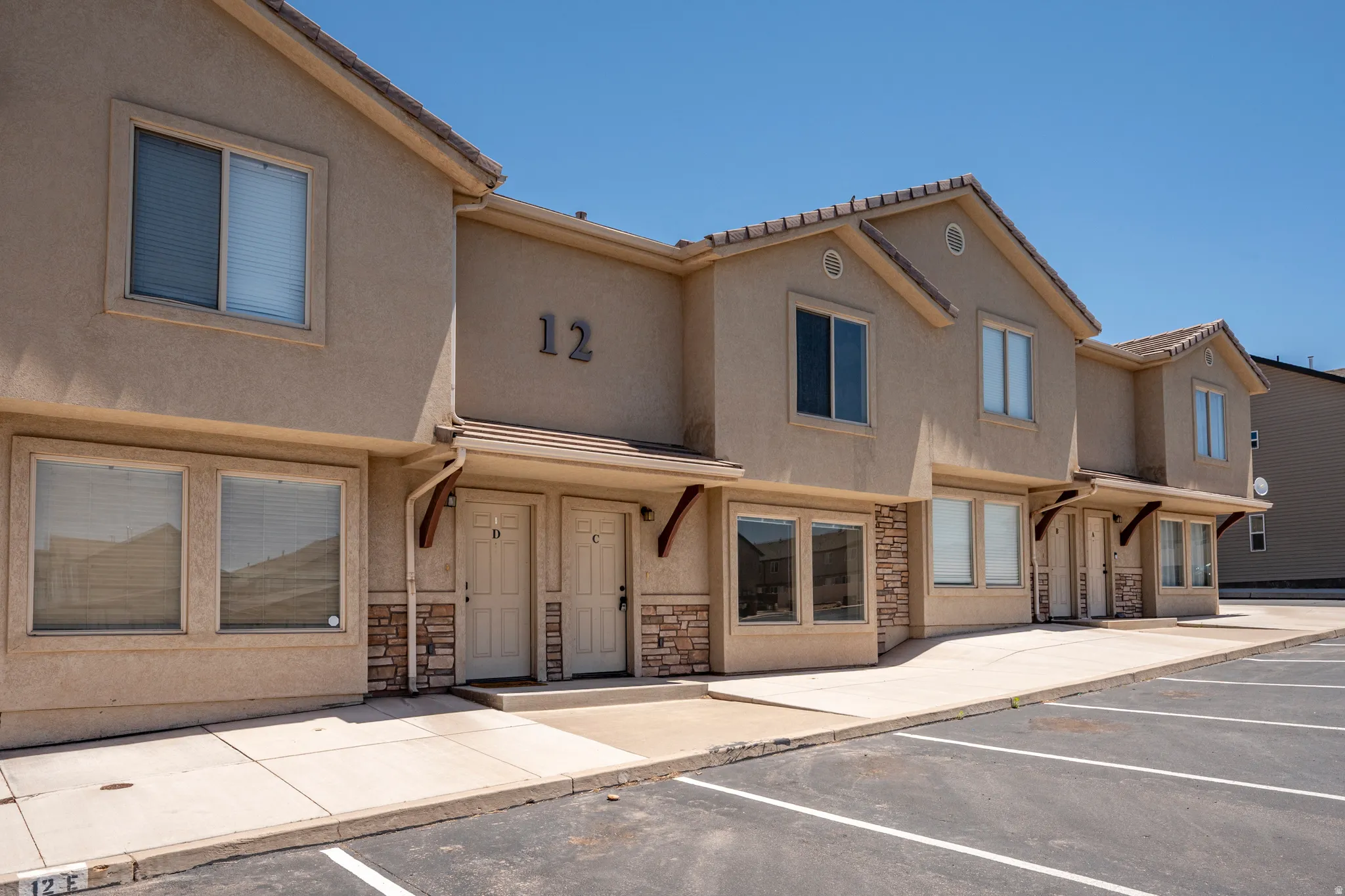 Tan stucco exterior with stone veneer accents