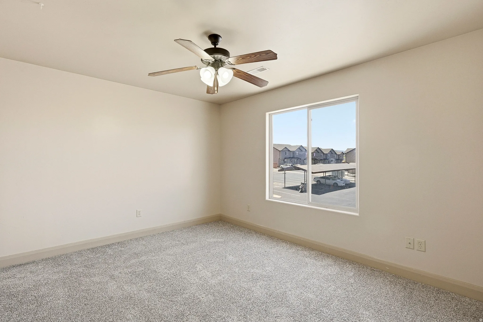 Neutral wall finishes, recessed base molding, and gray carpeting