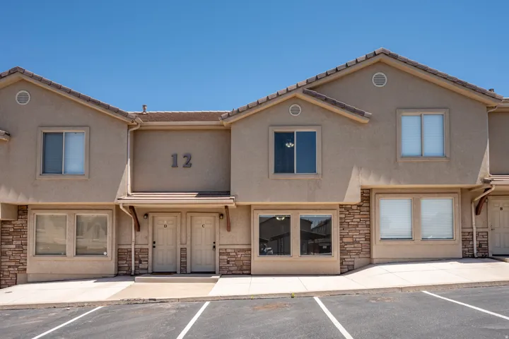 Multi-unit building featuring stucco and stone veneer exterior