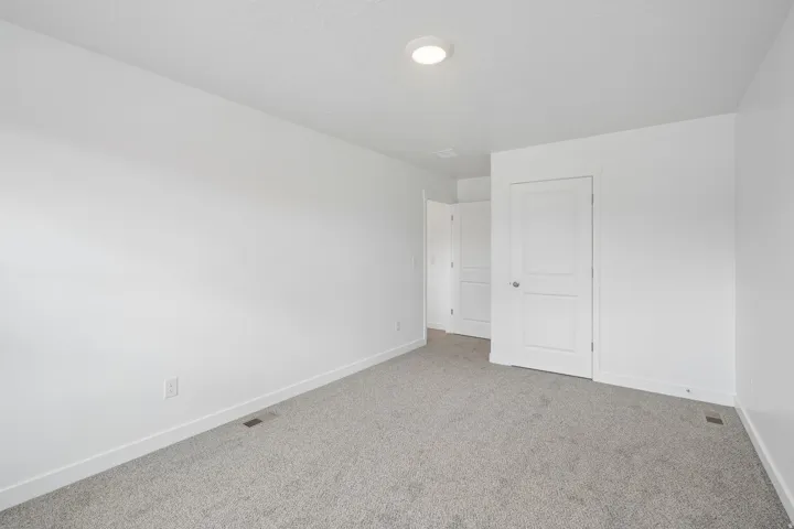 Neutral color palette with light gray carpeting and white walls