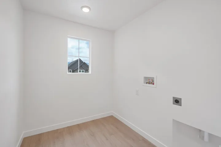 Recessed ceiling lighting, wood-finish flooring, and a single window