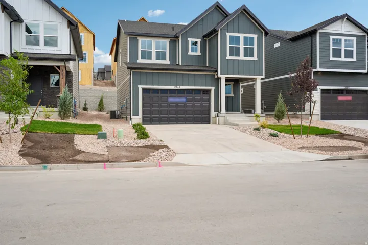 Contemporary two-story exterior with dark siding and white trim accents