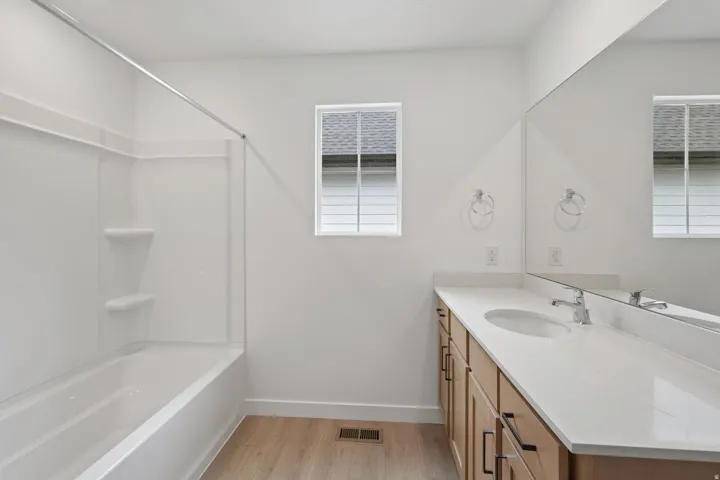 Full vanity with an integrated sink and light-toned countertop