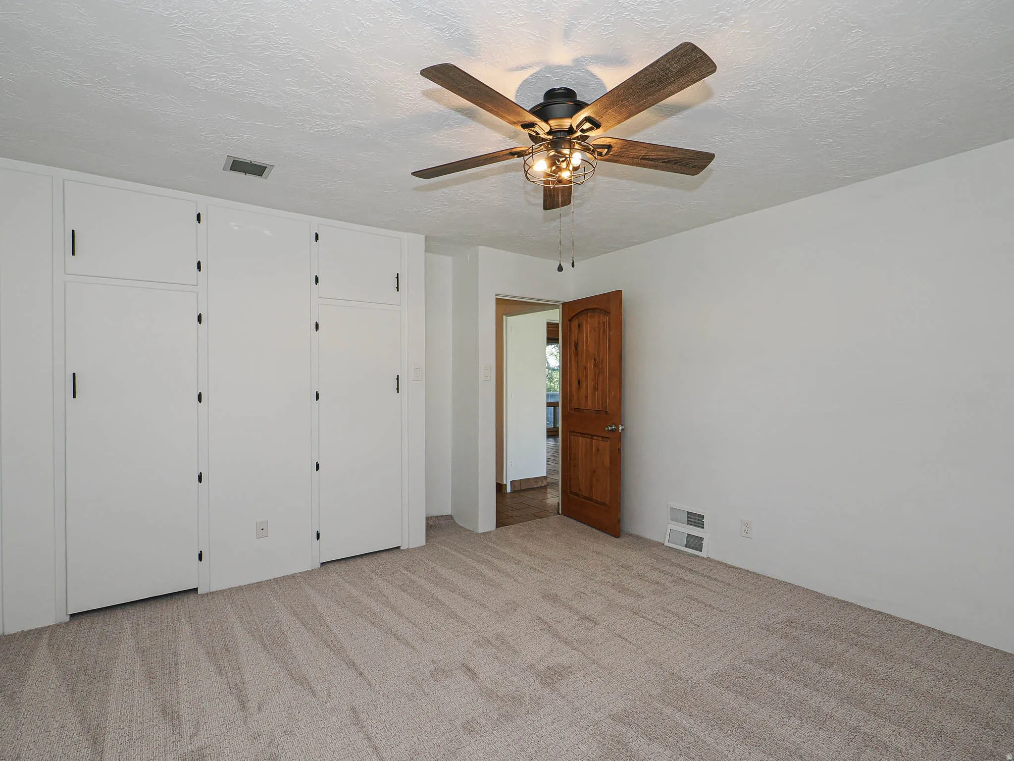 Built-in white cabinetry providing ample storage