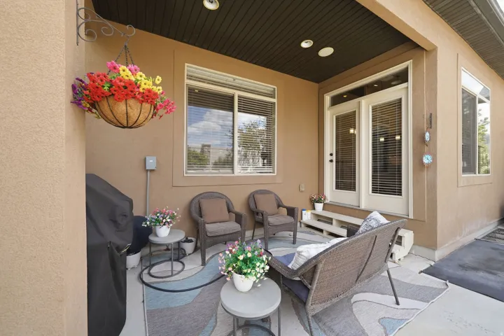 Covered patio featuring recessed lighting, a stucco exterior, double French doors, and multiple windows