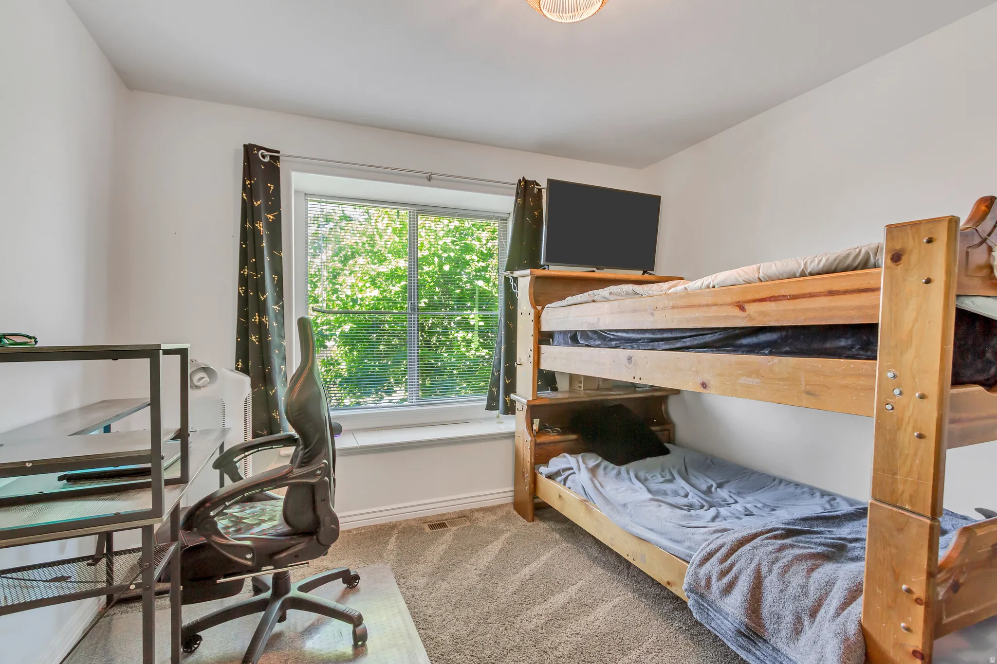 Carpeted room featuring a large window with a white frame and a deep sill