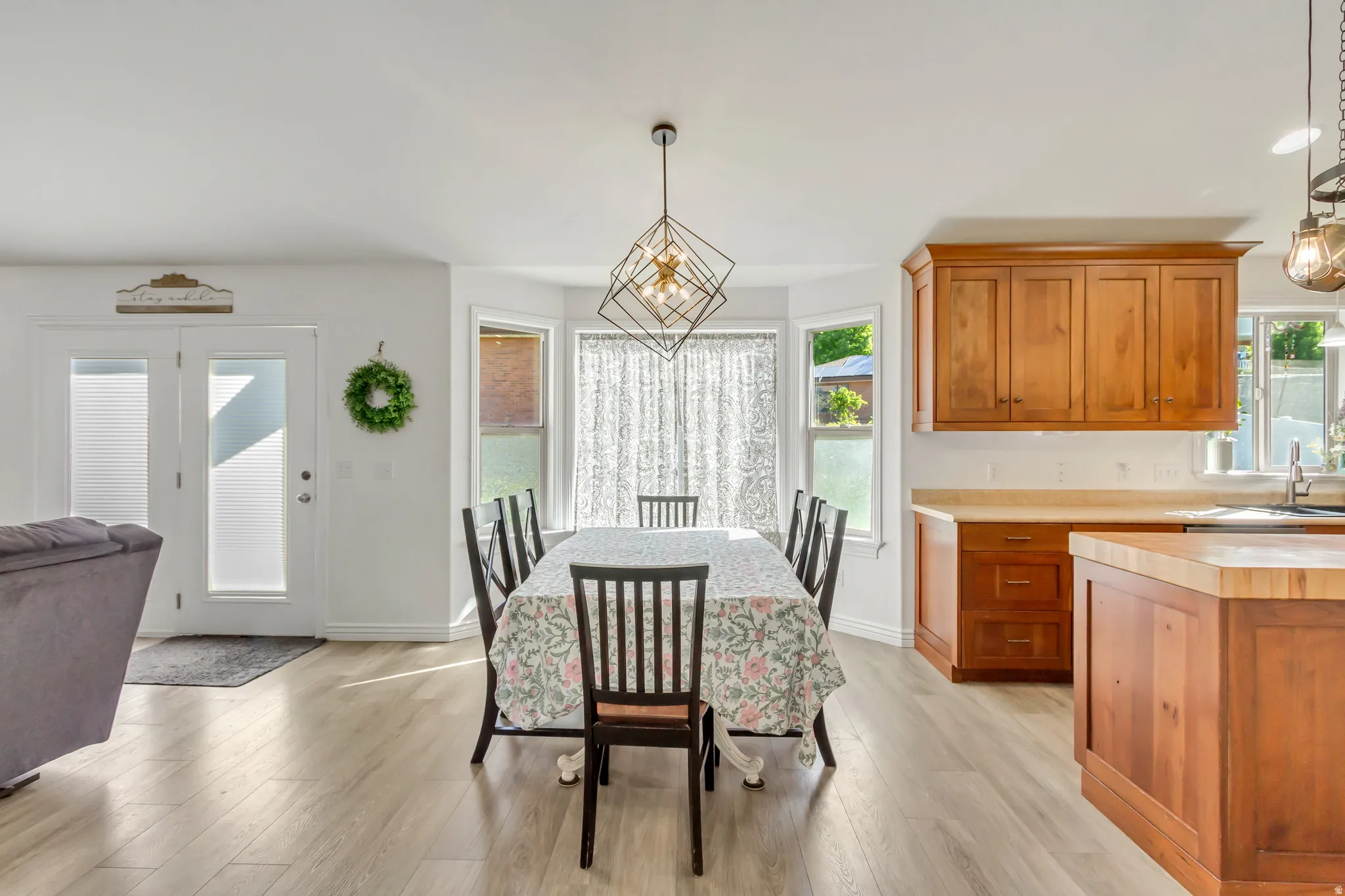 Open-concept dining and kitchen area with light wood-finish flooring