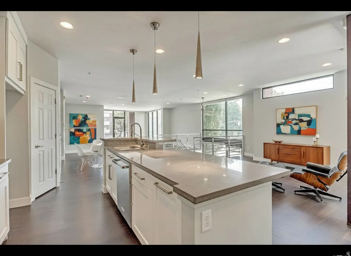 Spacious kitchen island featuring a light-toned countertop and integrated sink