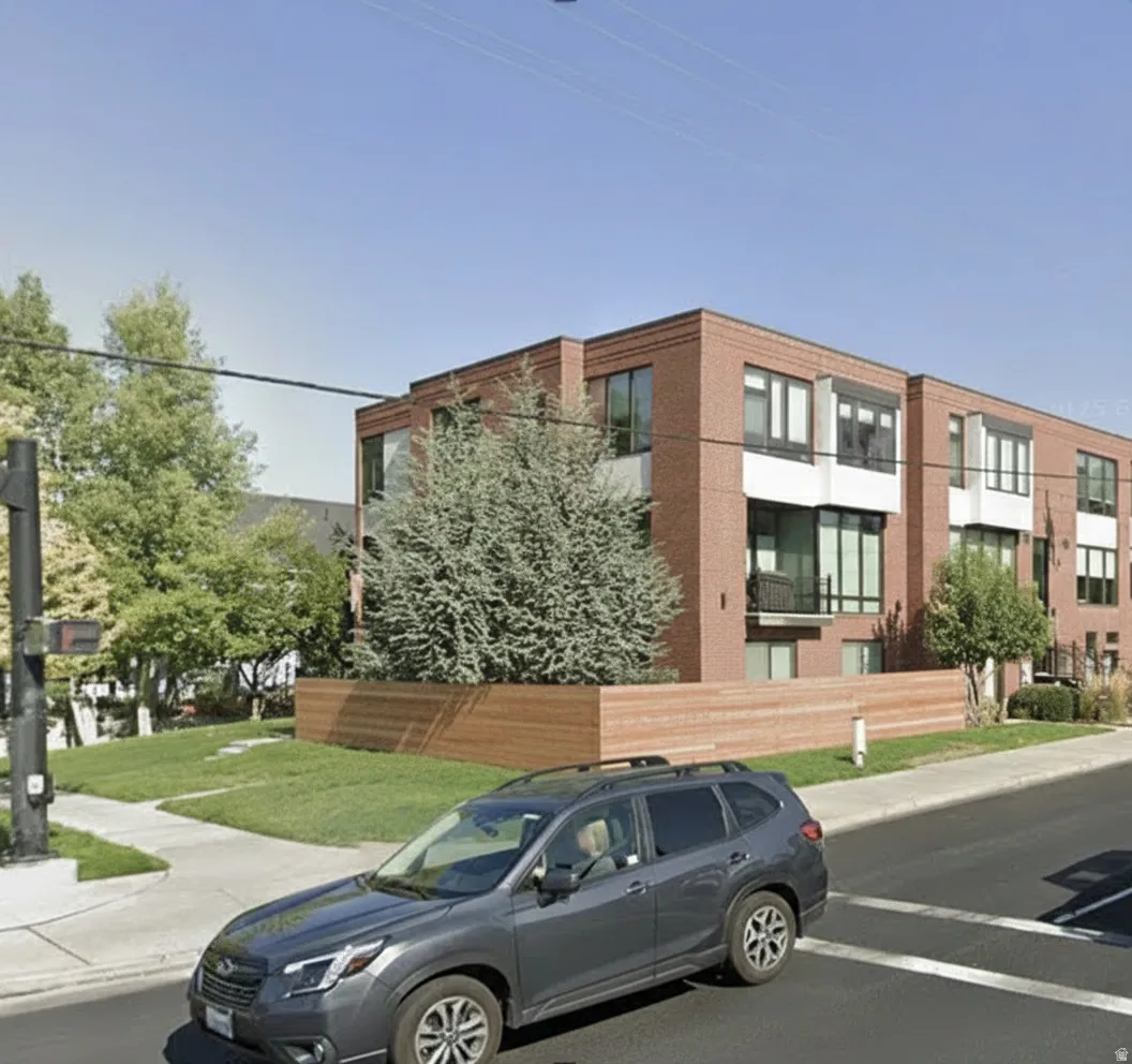 Contemporary multi-level building with brick and white panel exterior