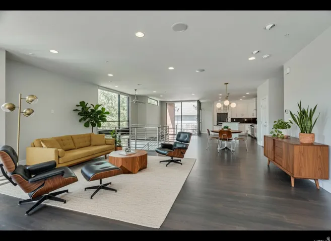 Open-concept living area with dark wood-finish flooring