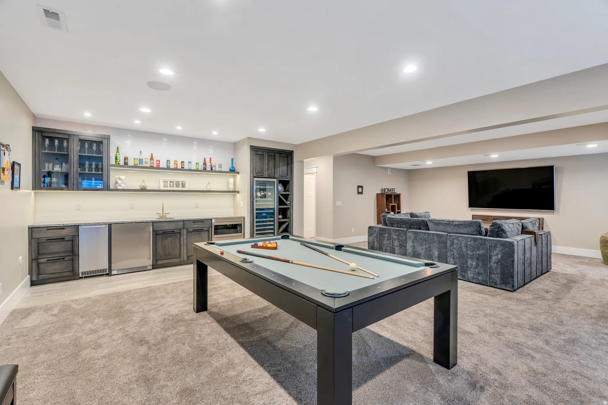 Showcasing room for pool table, wet bar kitchenette, and the family room