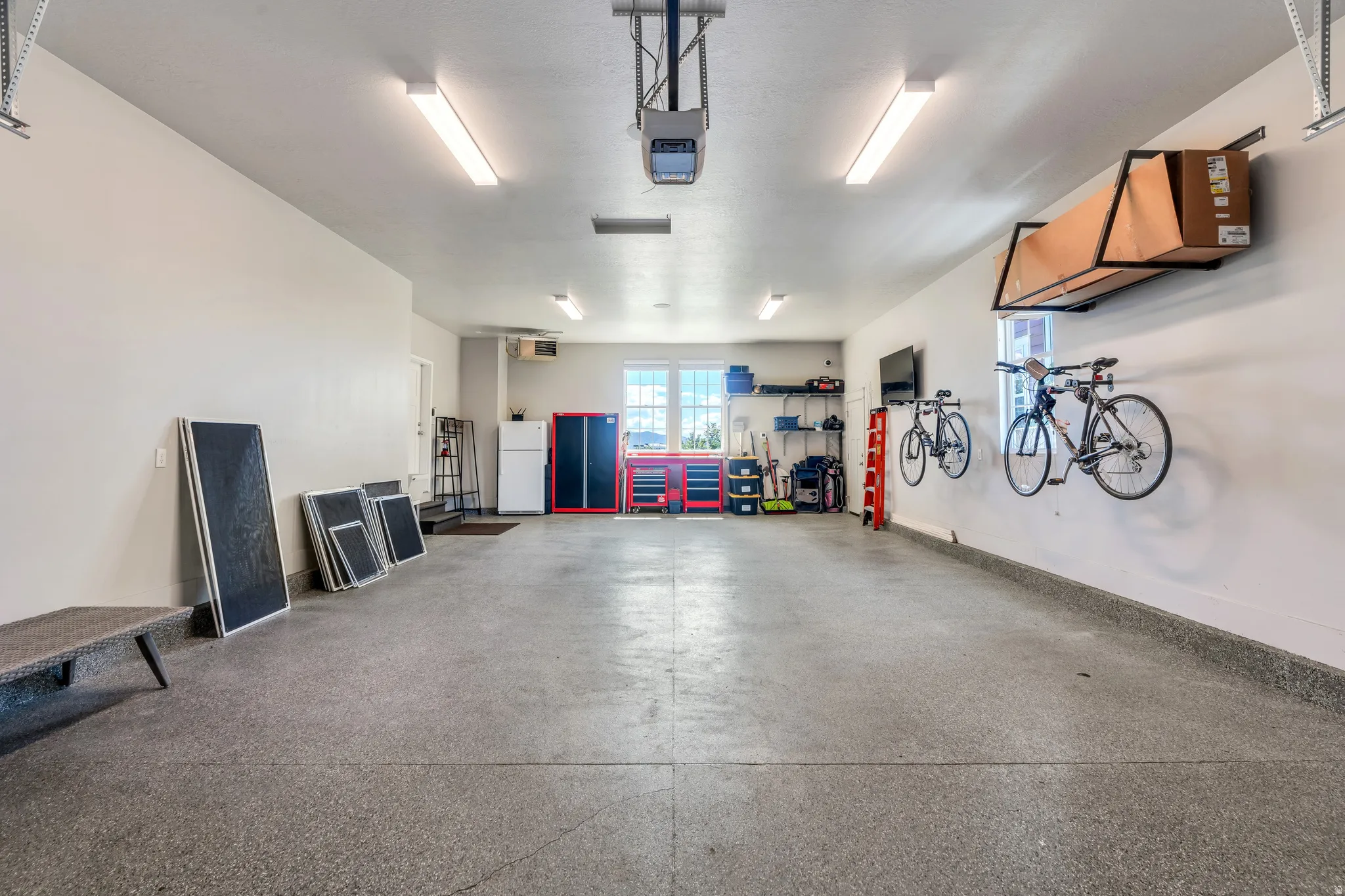 Generous 4 car garage with ample workshop and storage space