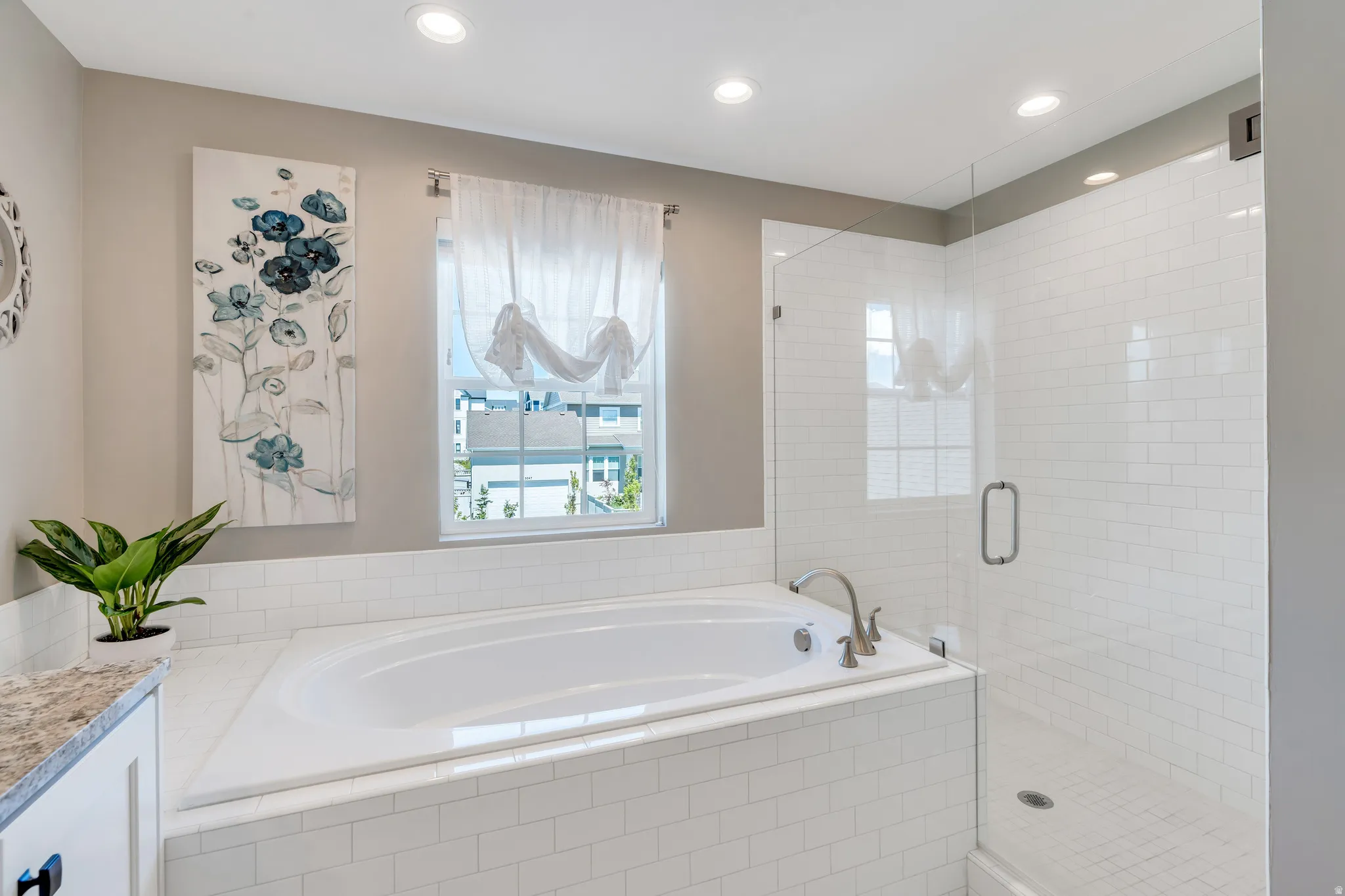 Featuring the generous soaking tub, euro shower and natural light flooding through