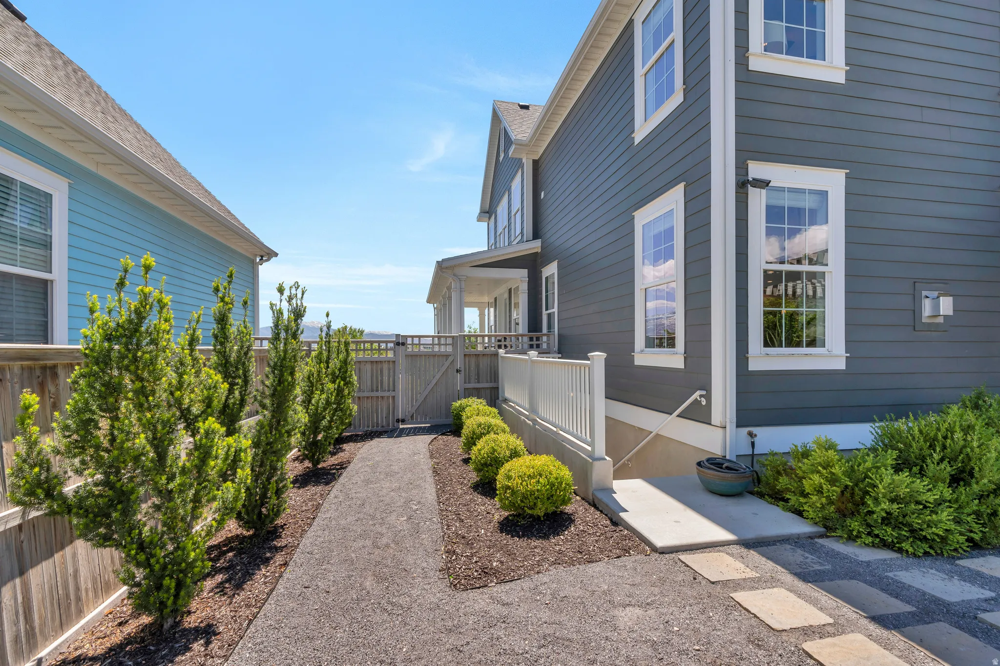 Features the side gate entrance, and private downstairs access