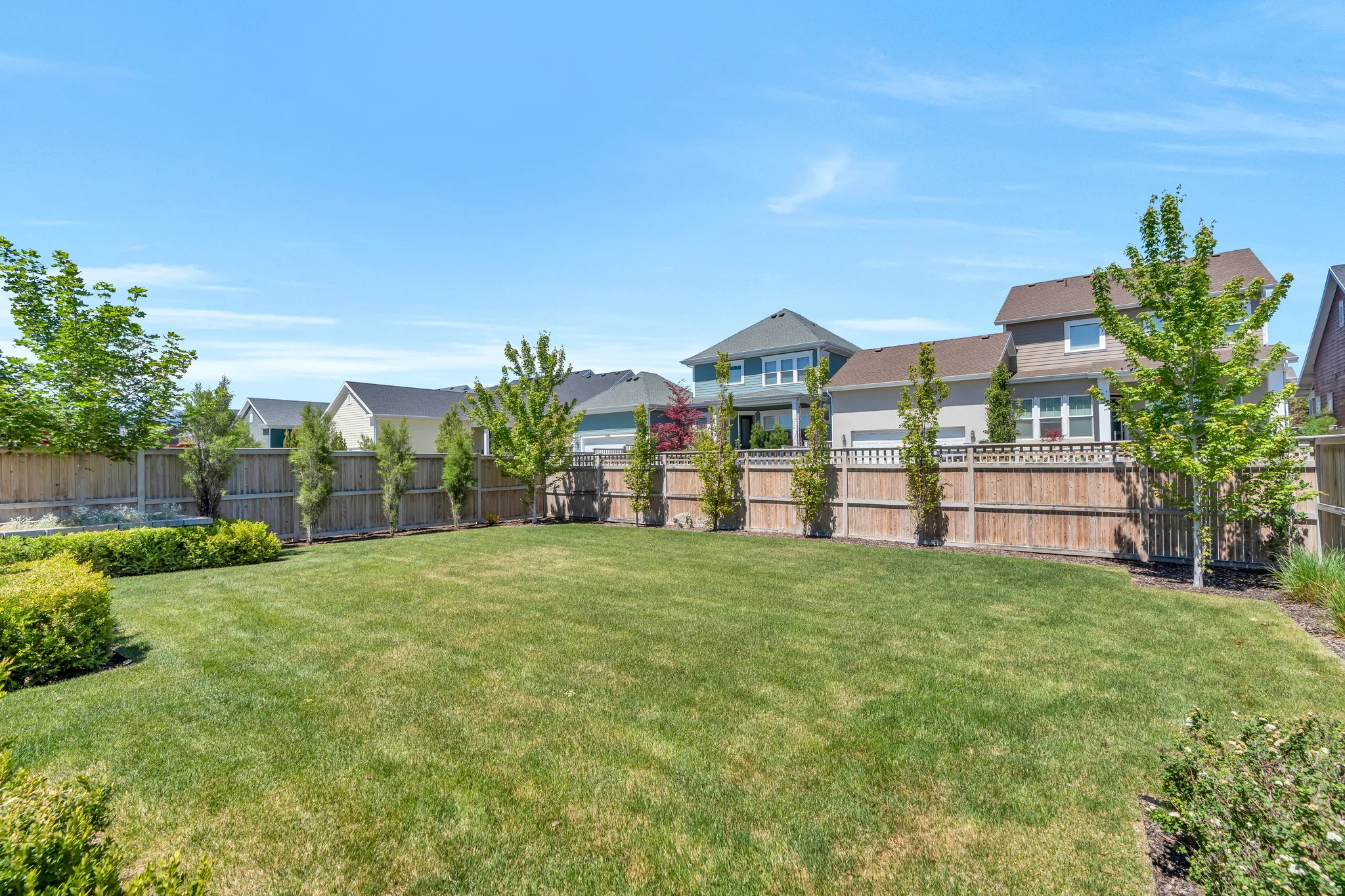 Expansive fully gated yard with mature landscaping for additional privacy