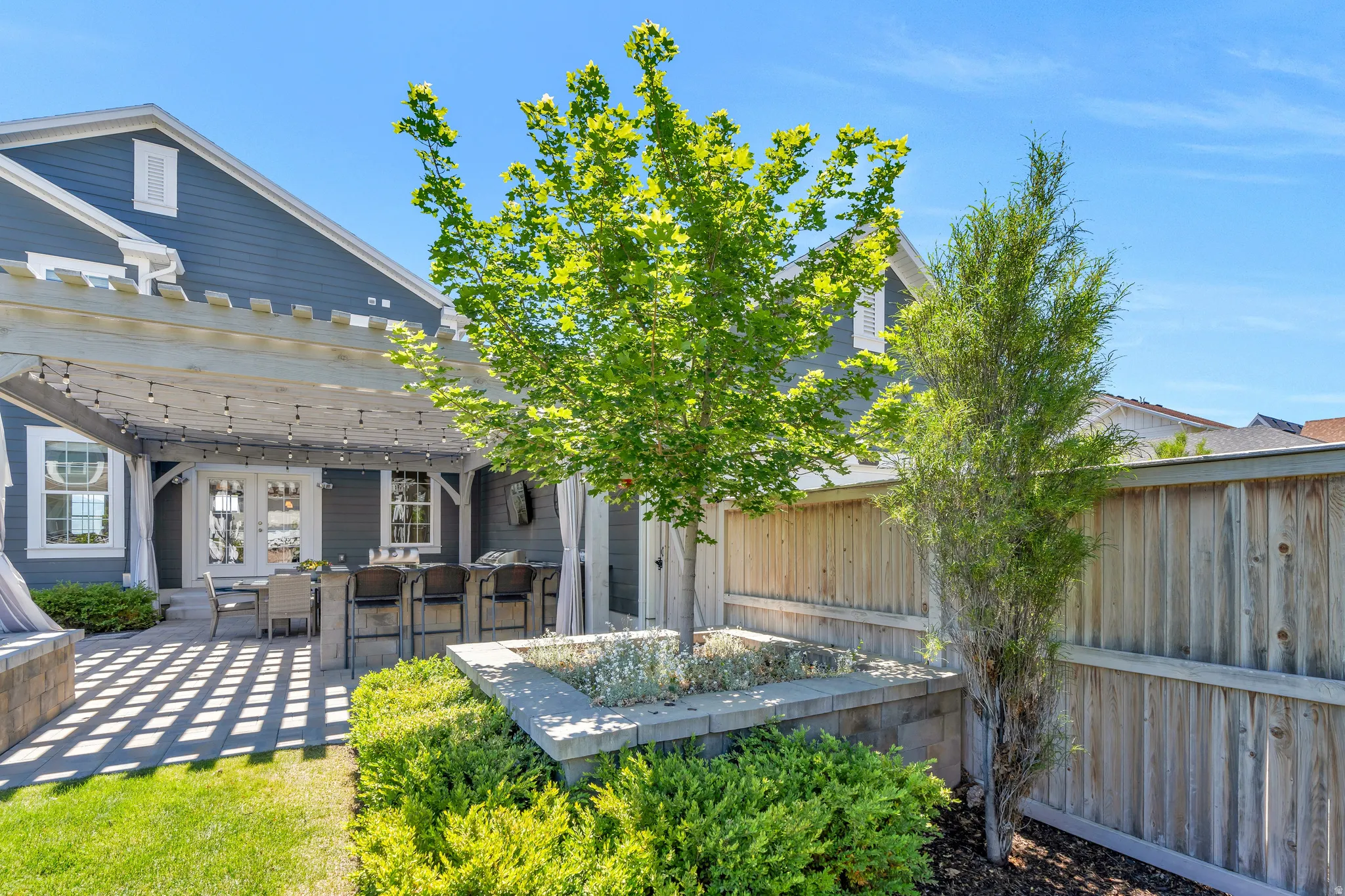 Featuring the homes immaculate mature landscaping and greenery