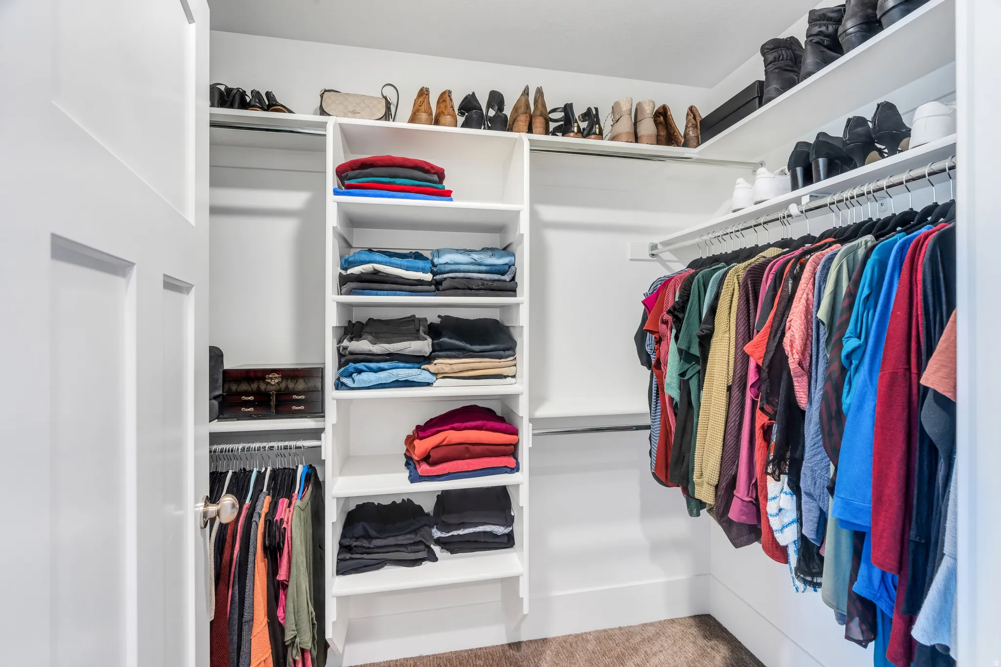 Spacious secondary primary closet featuring ample hanging racks, and built in shelving