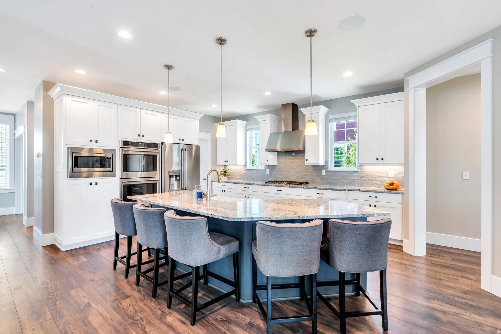 Featuring light granite countertops, ample cabinet space, and generous breakfast bar seating