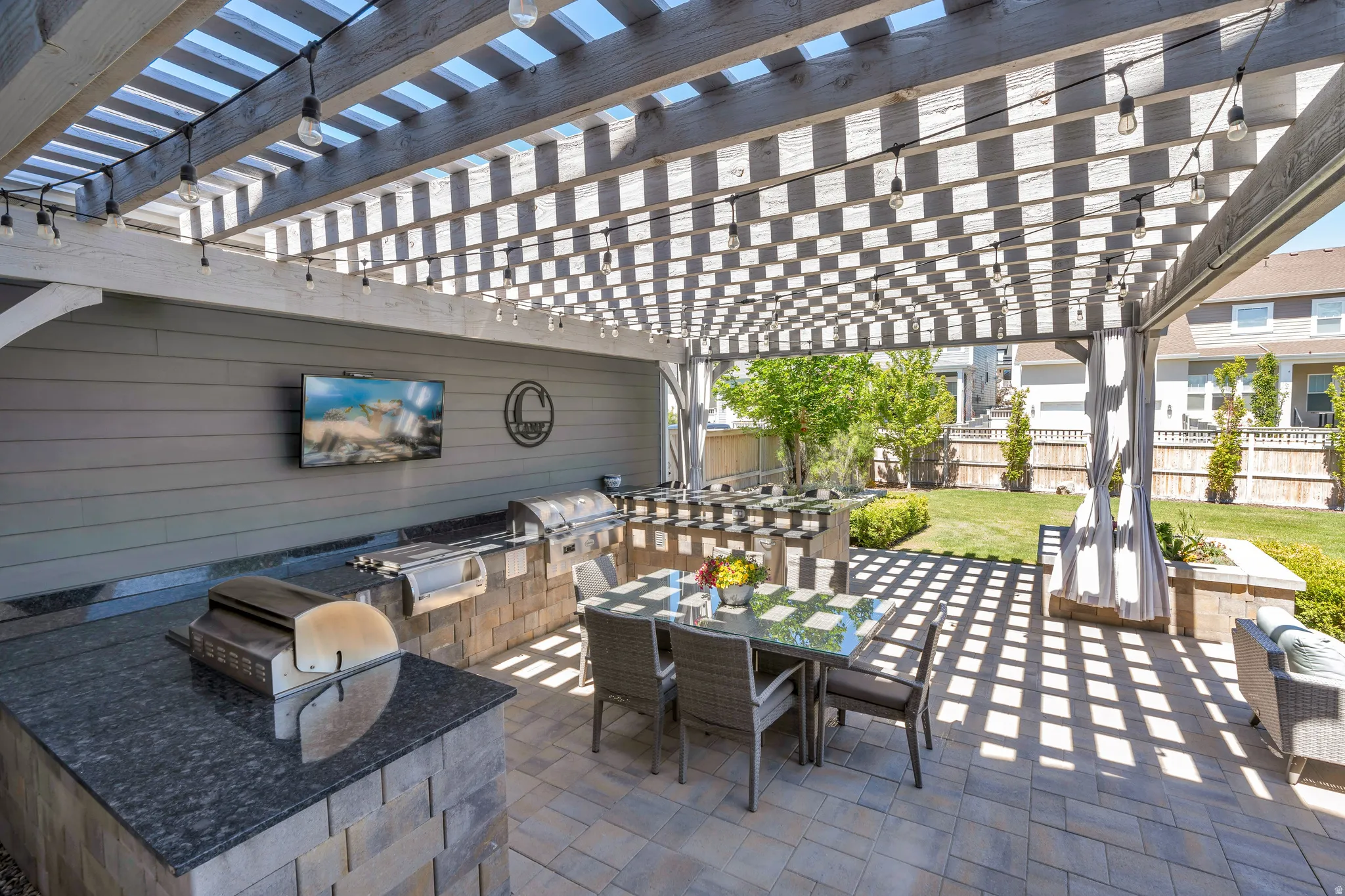 Gorgeous, covered pergola, with picnic & dry bar seating, featuring stunning grill master station