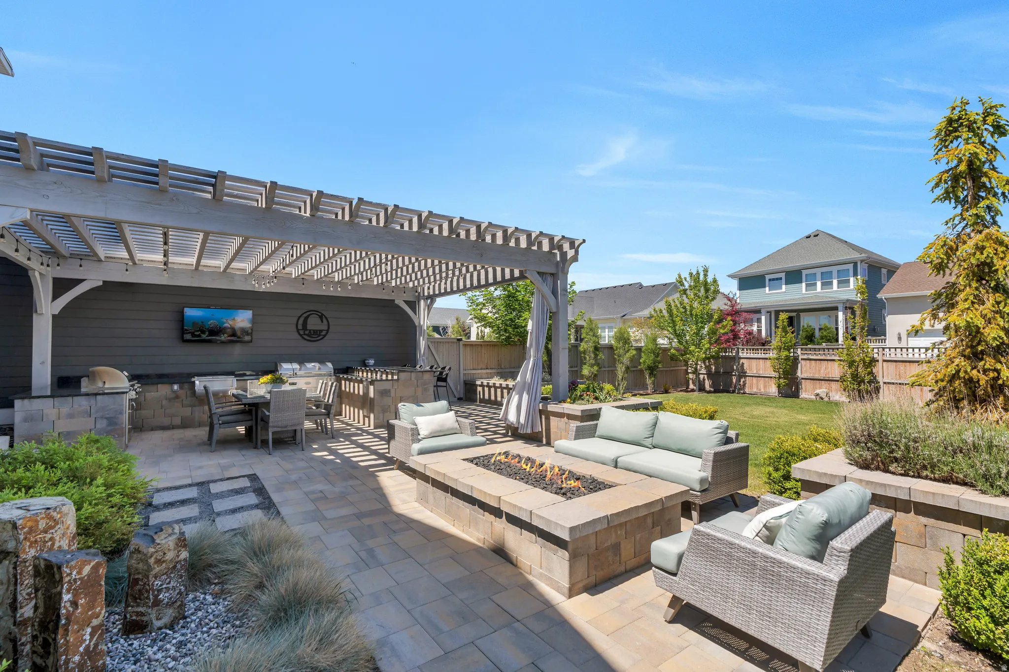 Features both the pergola covered picnic area, firepit and grassy areas