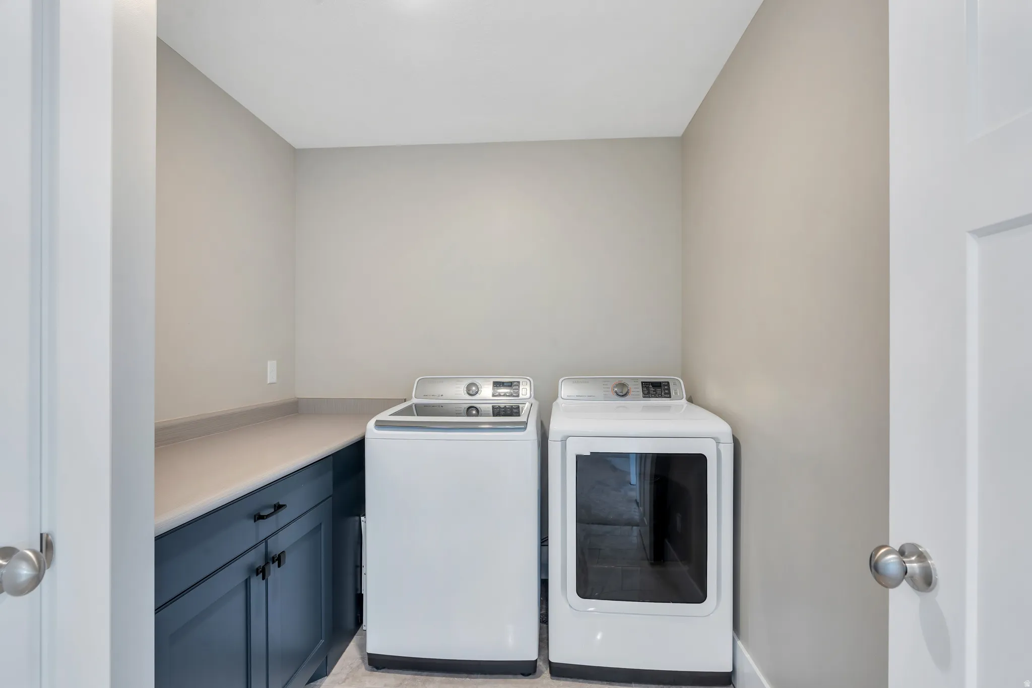 Enjoy this spacious laundry room with ample storage cabinets, and counterspace for all your needs