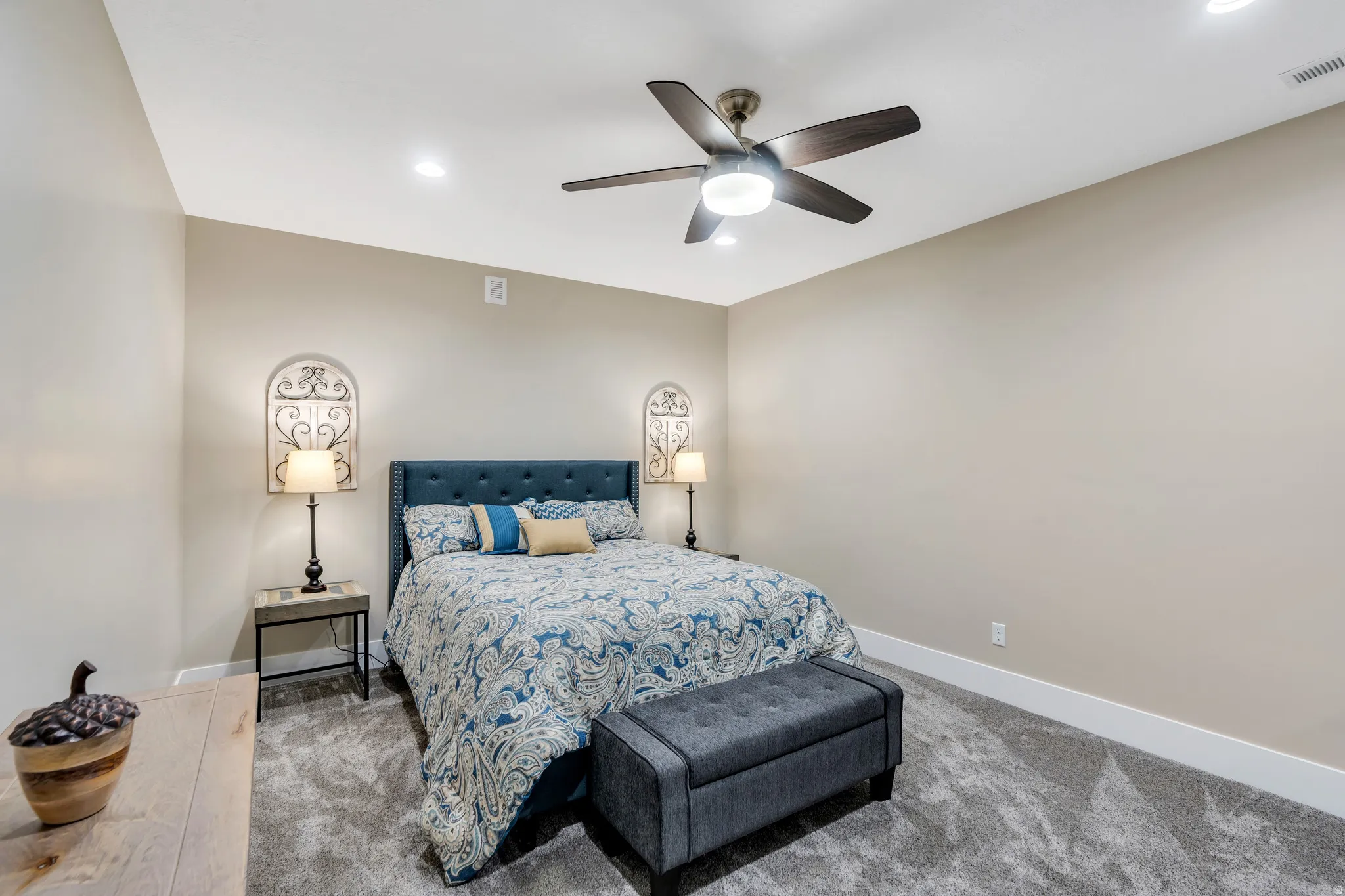 Spacious bedroom featuring neutral walls, and plush carpet
