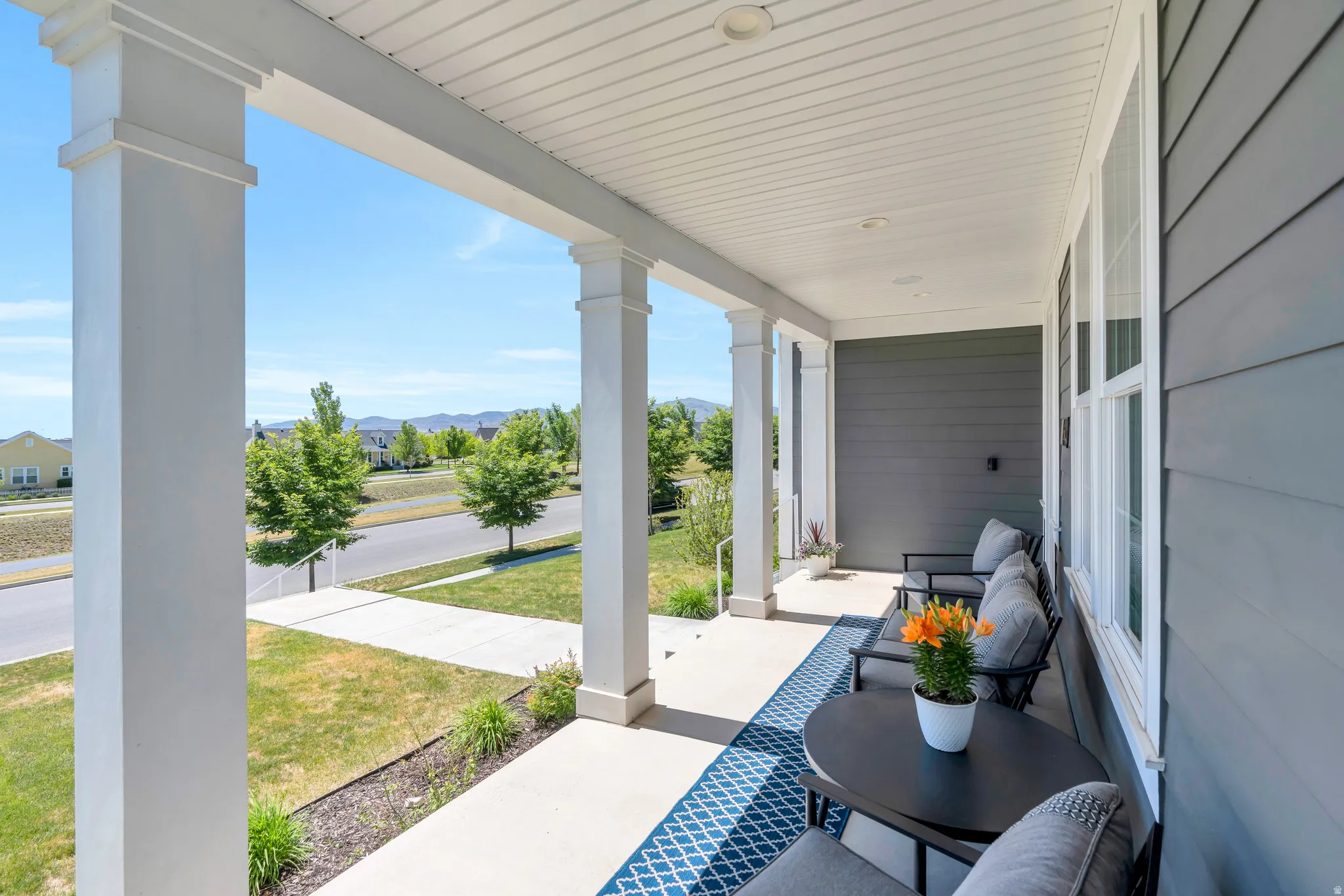 Stunning covered wrap around porch featuring ample space for outdoor furniture