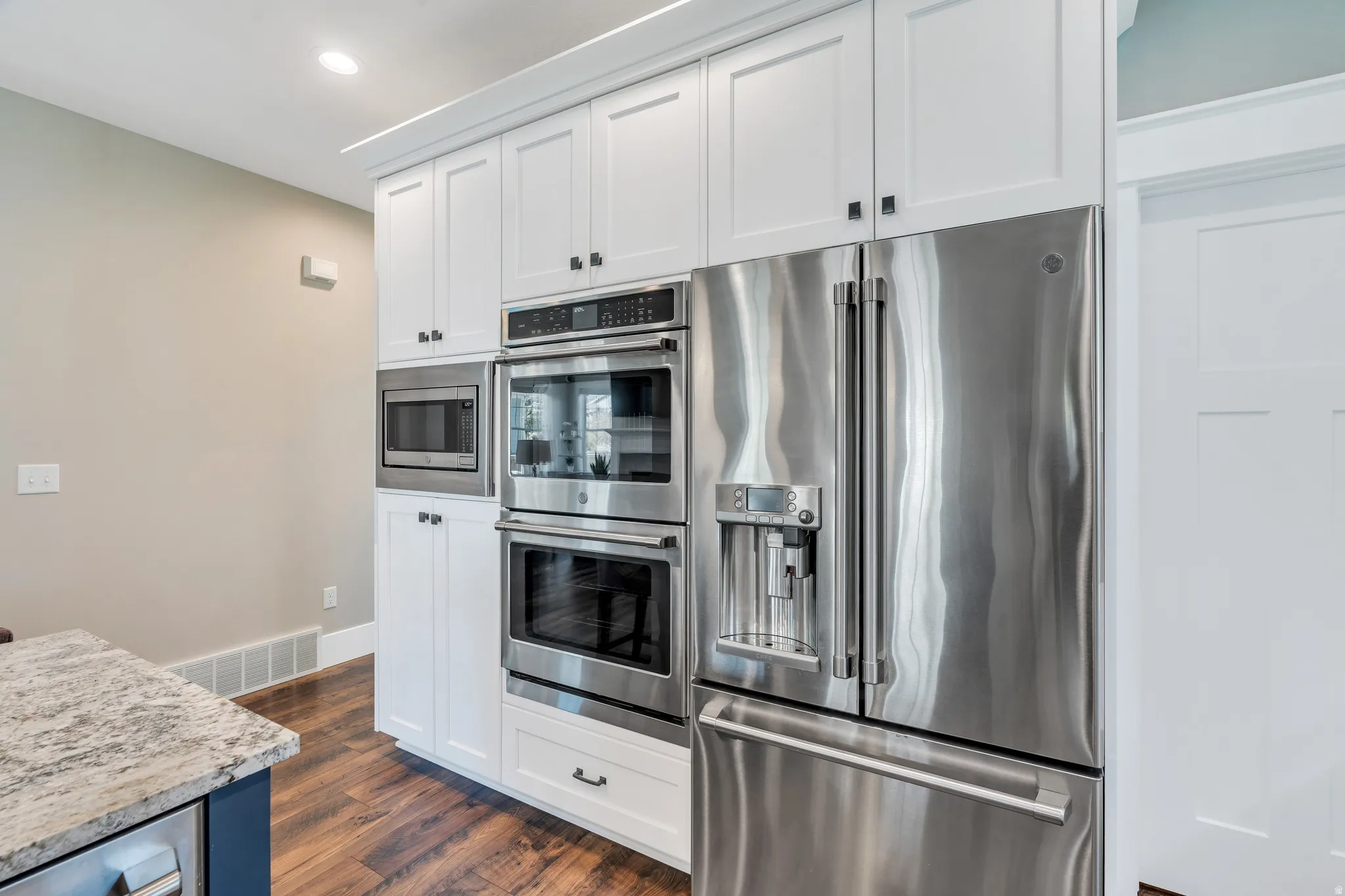 Features pristine stainless-steel appliances, bright cabinets and contrasting black hardware