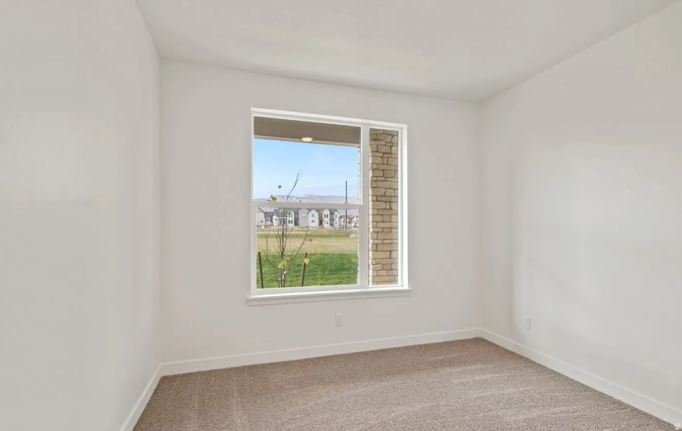 Room with neutral wall paint and carpet flooring