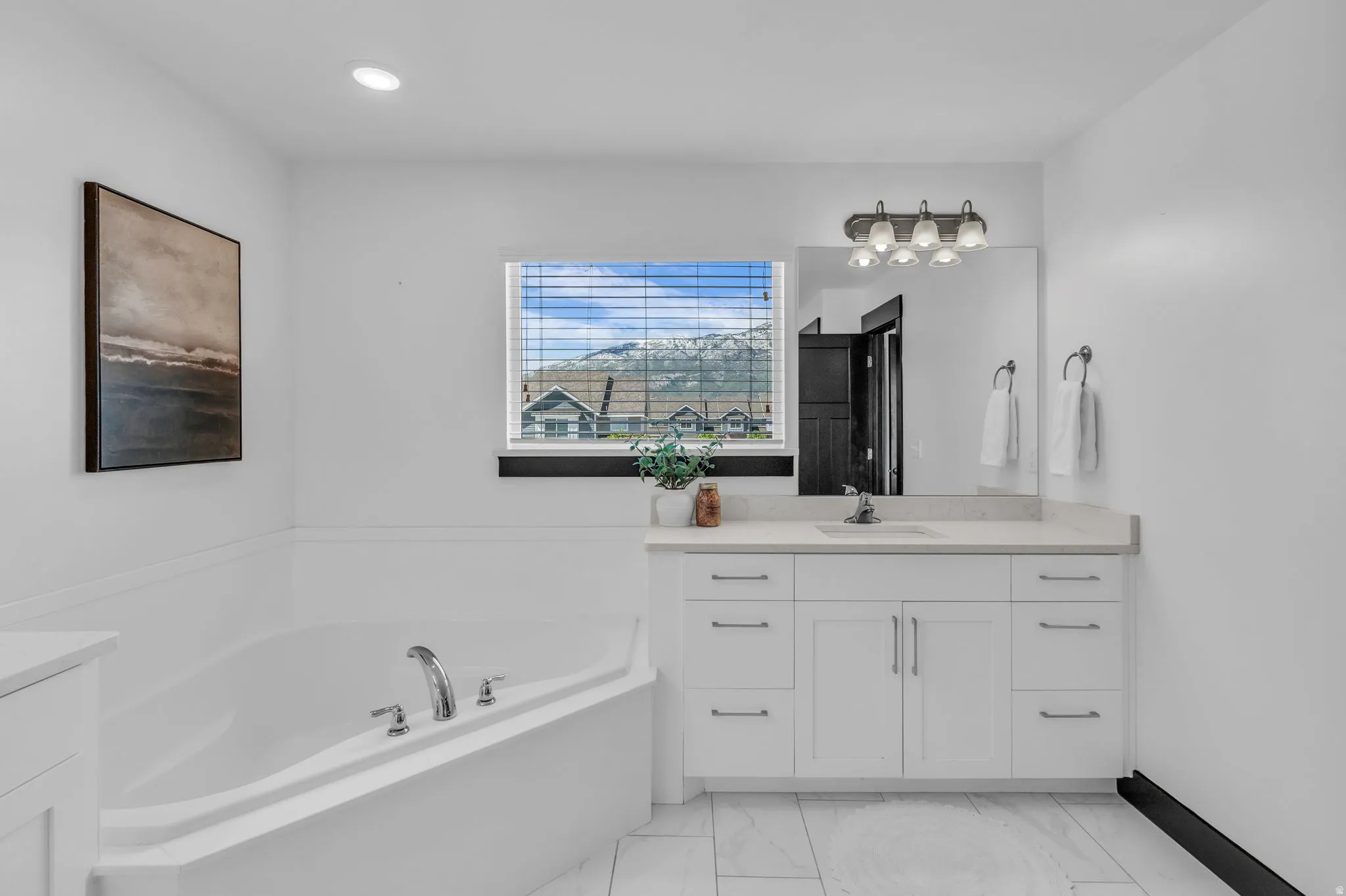Corner soaking tub with deck-mounted chrome fixtures