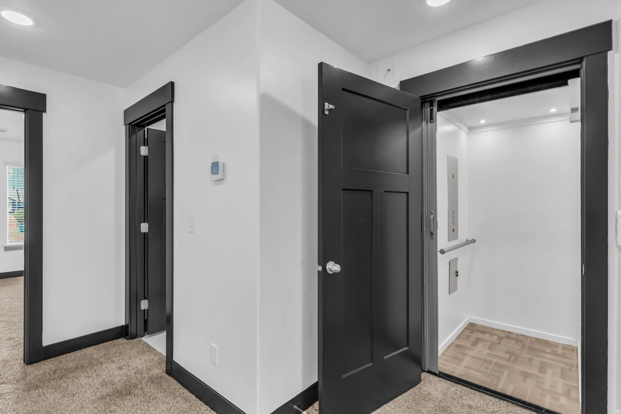 Integrated residential elevator featuring a grab bar and recessed lighting