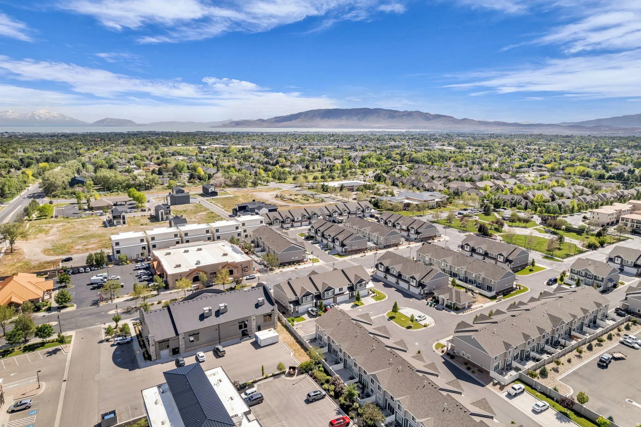 Expansive aerial view showcasing a developed residential area with numerous townhomes