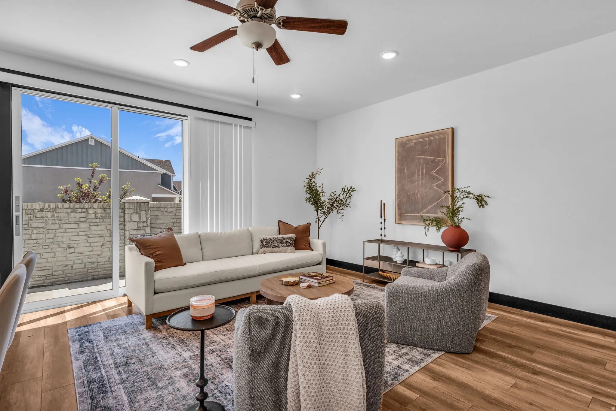 Open living area featuring wood-finish flooring, recessed lighting, and a ceiling fan