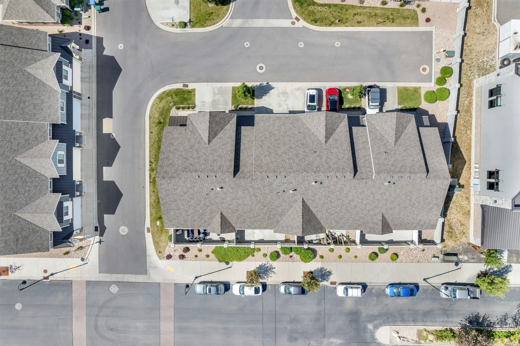 Townhome community with asphalt shingle roofs and integrated driveways