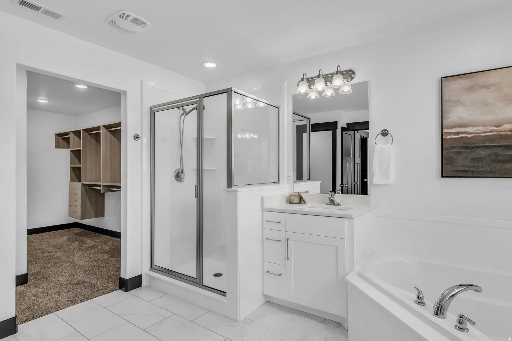 Bathroom featuring white tile flooring and a built-in corner tub with chrome fixtures