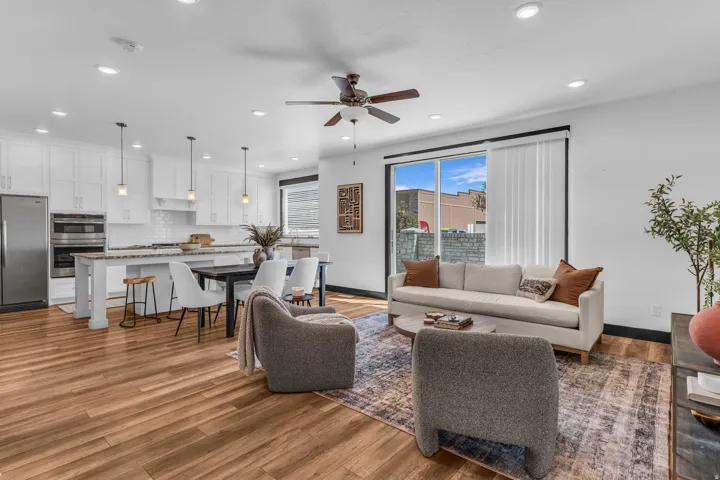Open-concept living area featuring wood-finish flooring, recessed lighting, and a ceiling fan