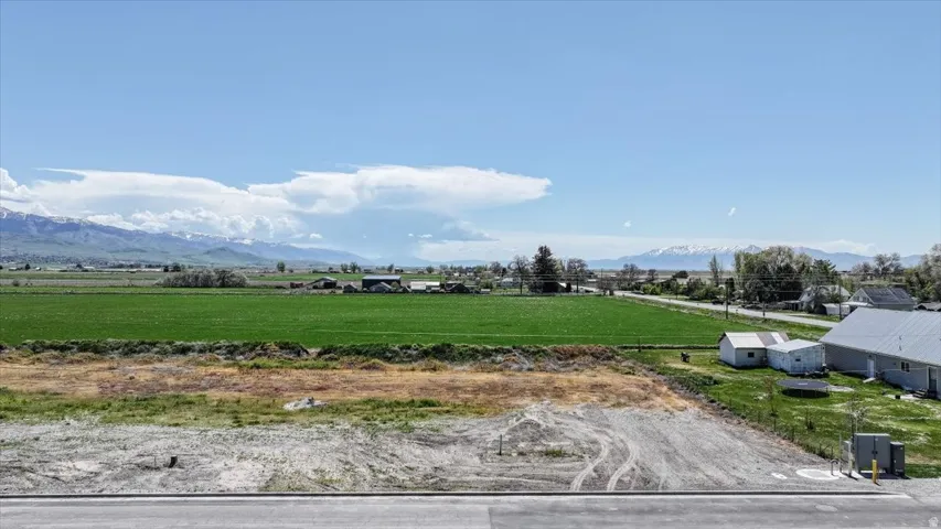 Expansive undeveloped land parcel featuring a gravel surface and direct road frontage