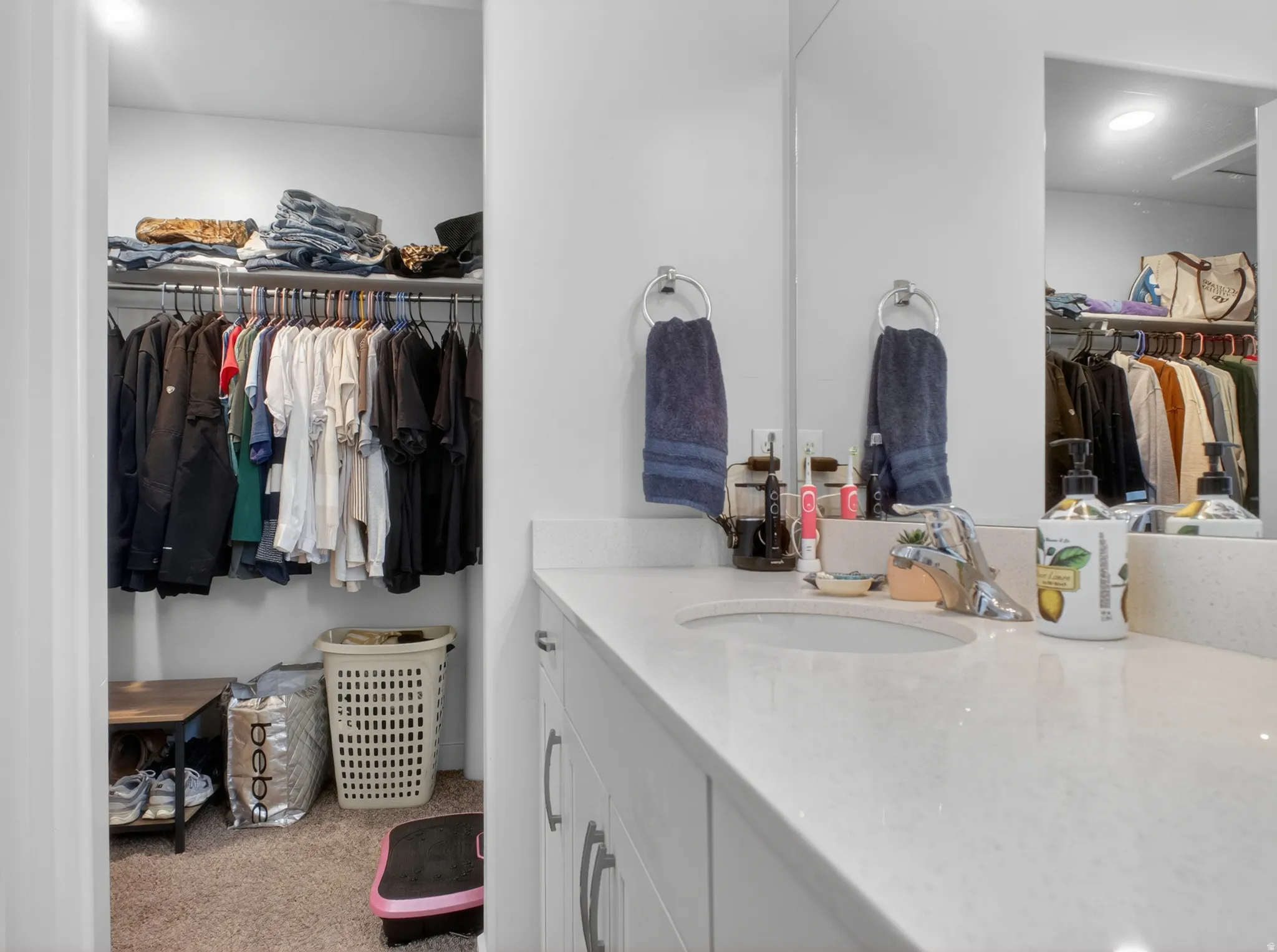 Double vanity with undermount sinks, chrome faucets, and light-toned countertops