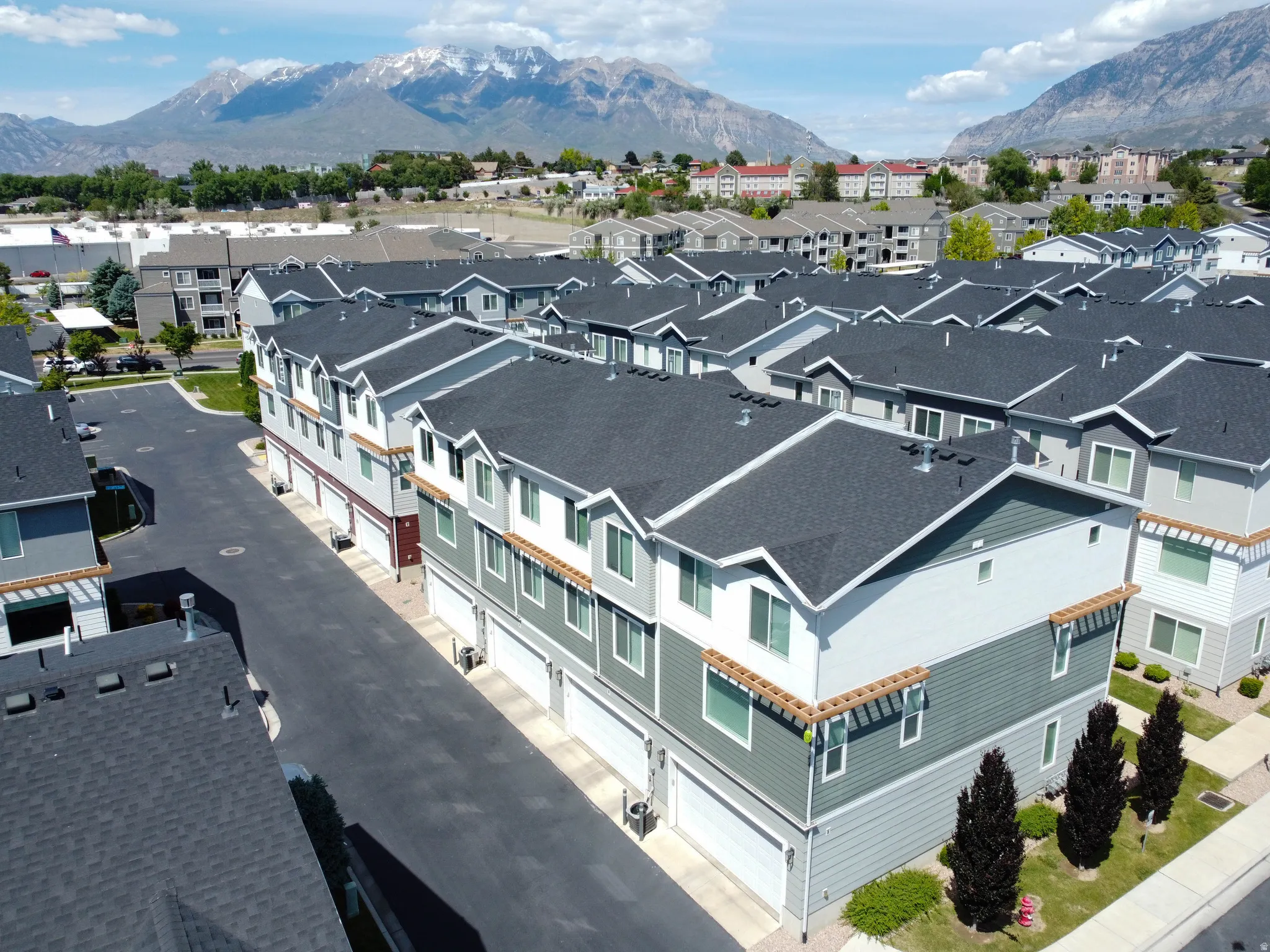 Modern townhome community featuring multi-level units with attached garages