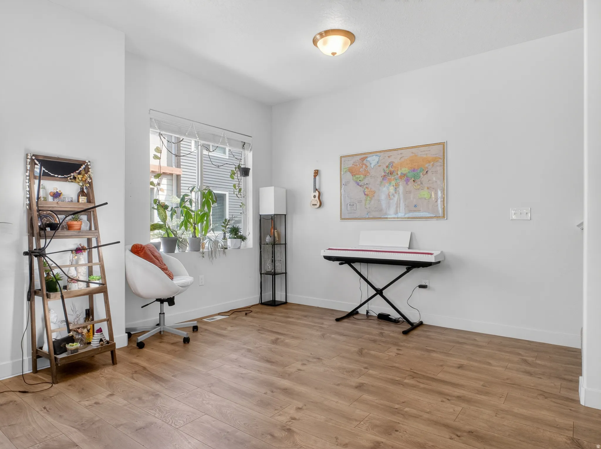 Bright room featuring wood-finish flooring and a large window