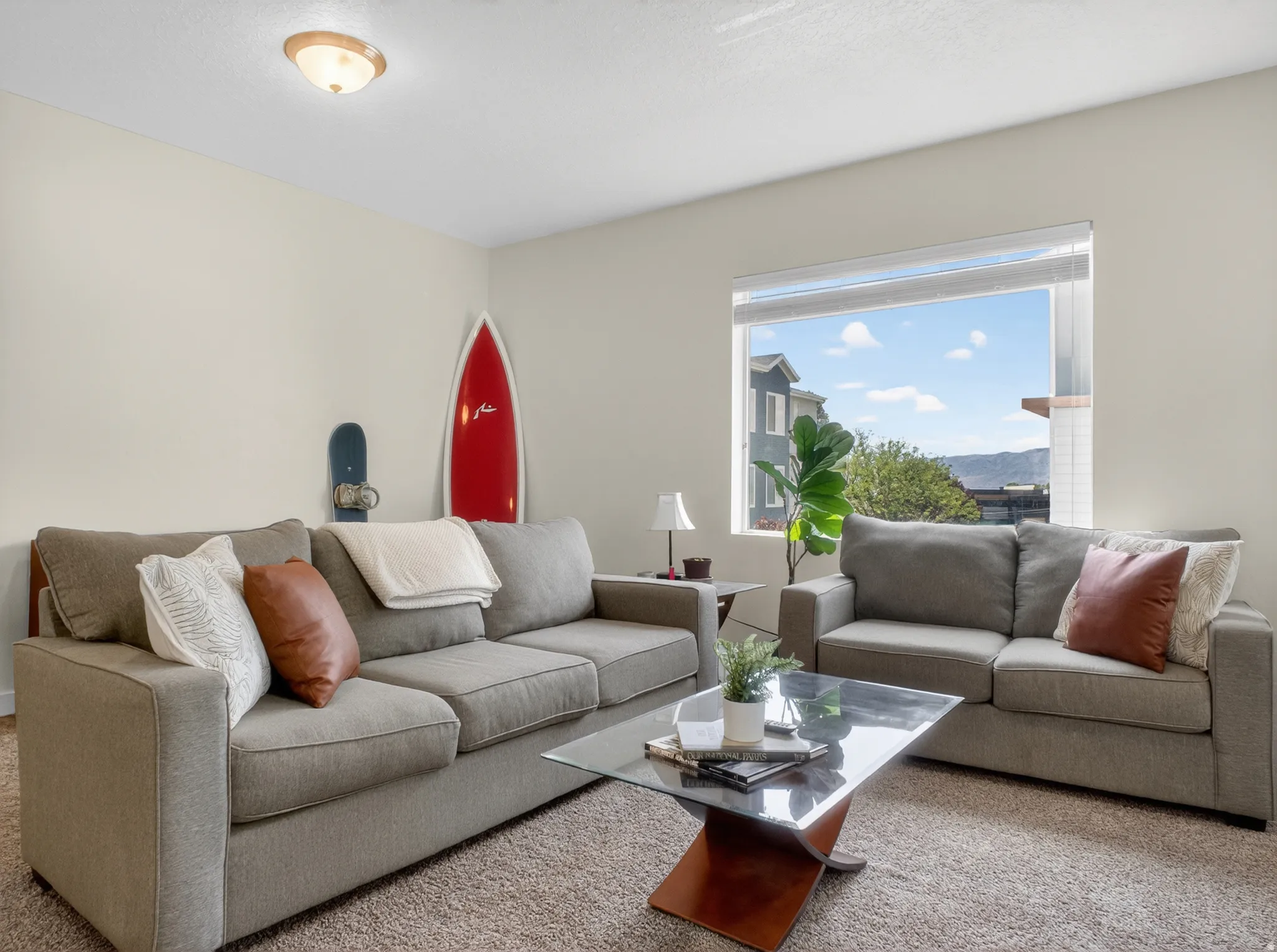 Living area with neutral wall color and carpeted flooring