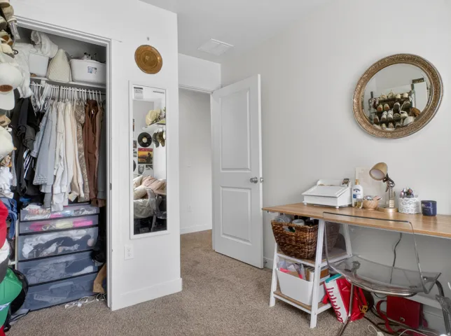 Room featuring light-colored carpet flooring and white walls