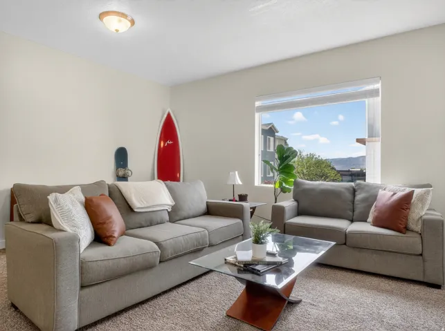 Living area with neutral wall color and carpeted flooring