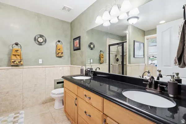 Primary Bathroom with Double Sinks, Tile, & Custom Paint