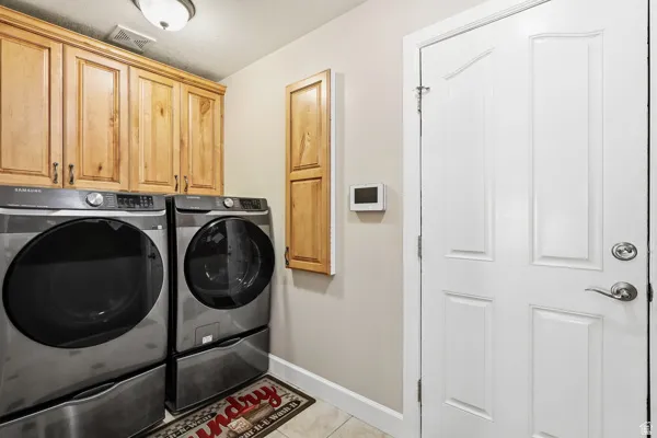 Laundry Area on Main Floor with Cabinets & Ironing Board