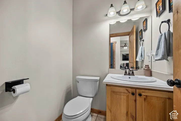 Bathroom vanity featuring a light-colored countertop, integrated sink, and wood-finish cabinetry
