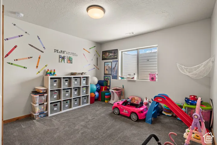 Spacious interior room with light gray carpeting and white walls